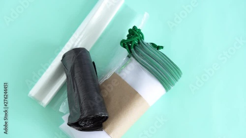 white transparent weaving kapron bags for multiple use when buying and storing fruits and vegetables to lie on a blue background next to plastic bags photo