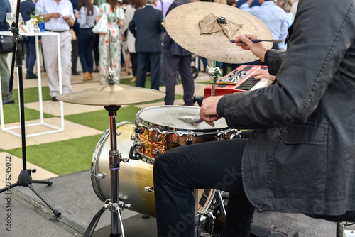 Valencia, Spain - June 20, 2019: Musician playing jazz to the battery hired to entertain the attendees of a business event. photo