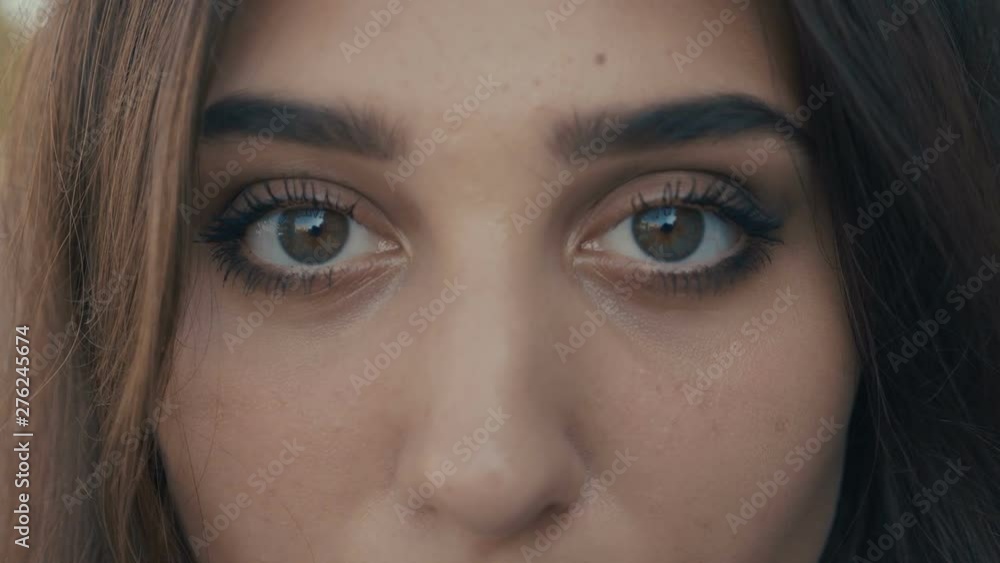 Close-up eyes of beautiful young woman brunette model looking at the camera. Girl with big eyes. Close-up eyes of beautiful young woman brunette model looking at the camera. Girl with big eyes.