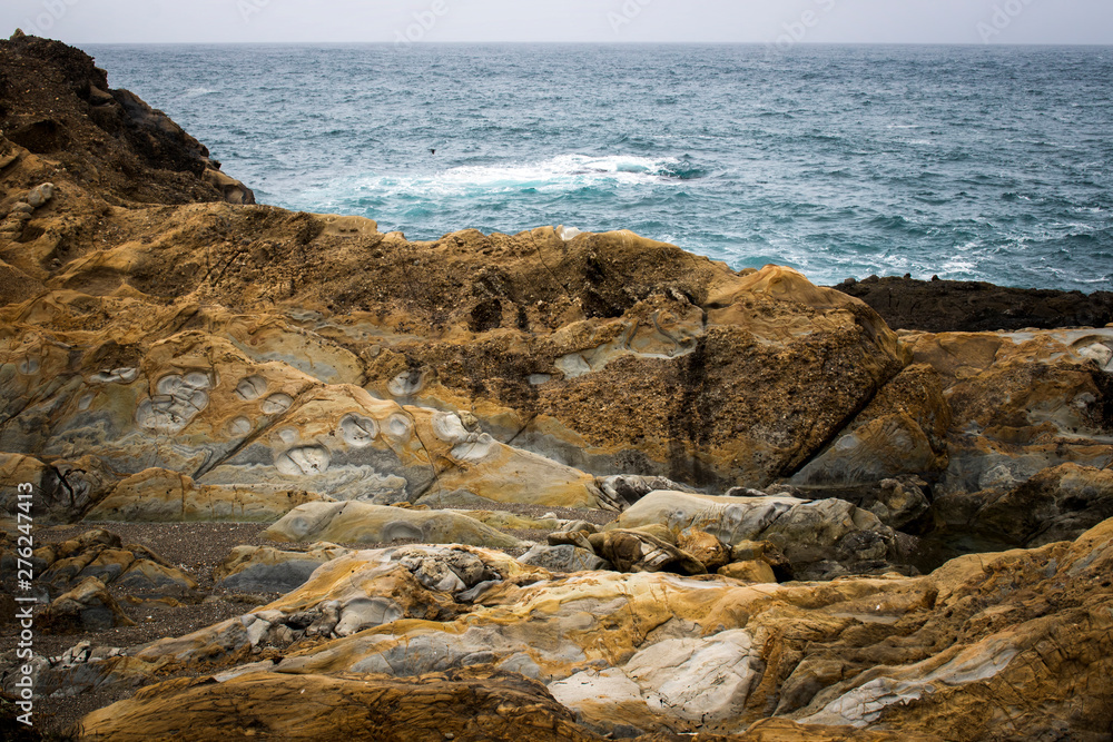 Colorful Rock Formations on California Coast with Ocean