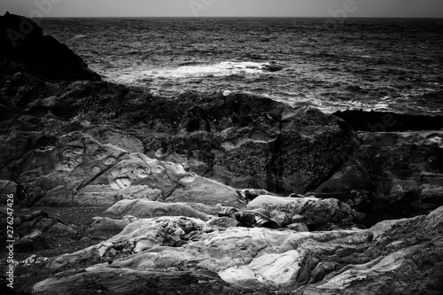 Black and White Rock Layers and Formations with Ocean in California