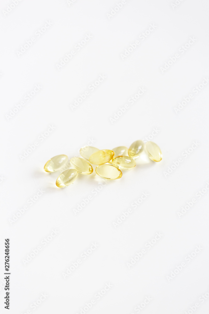 Group of Yellow Pills on White Background, CBD Capsules, Vitamins Group of Yellow Pills on White Background, CBD Capsules, Vitamins