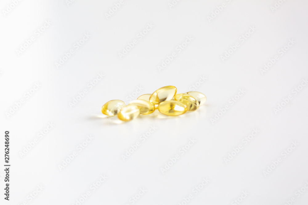 Group of Yellow Pills on White Background, CBD Capsules, Vitamins Group of Yellow Pills on White Background, CBD Capsules, Vitamins