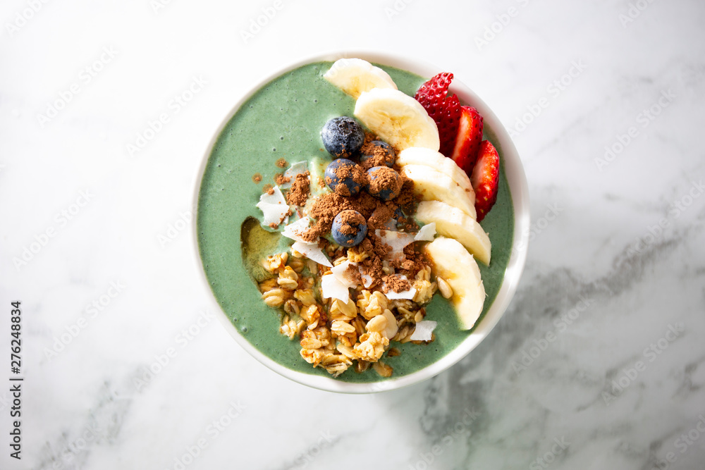 Spirulina yogurt with fruit in wooden bowl Spirulina yogurt with fruit in wooden bowl