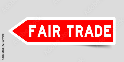 Arrow shape red color sticker in word fair trade on gray background
