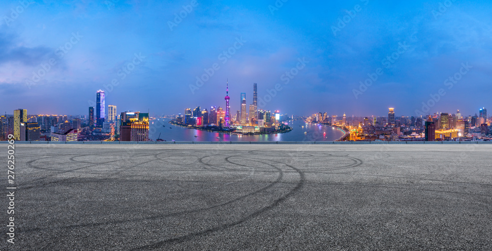 Shanghai skyline panoramic view with asphalt road at night,China