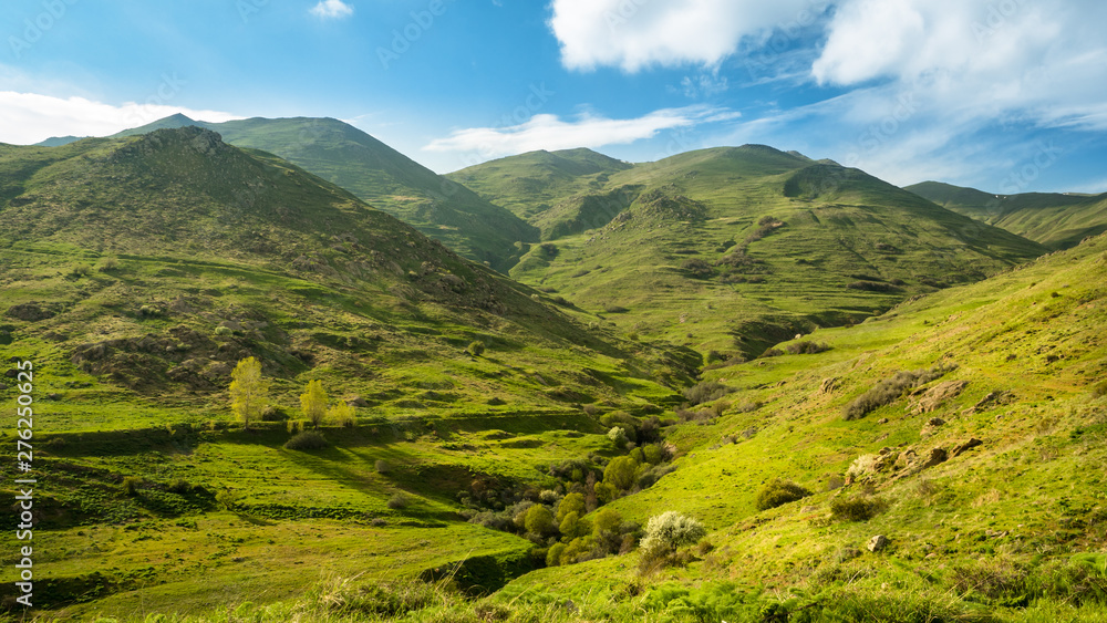 Obraz premium A stunning mountain view. Springtime landscape with meadow, mountains and sky. Zanzegur Mountains near Meghri village. Armenia