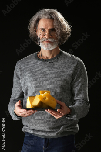 Male owner of cheese store ...