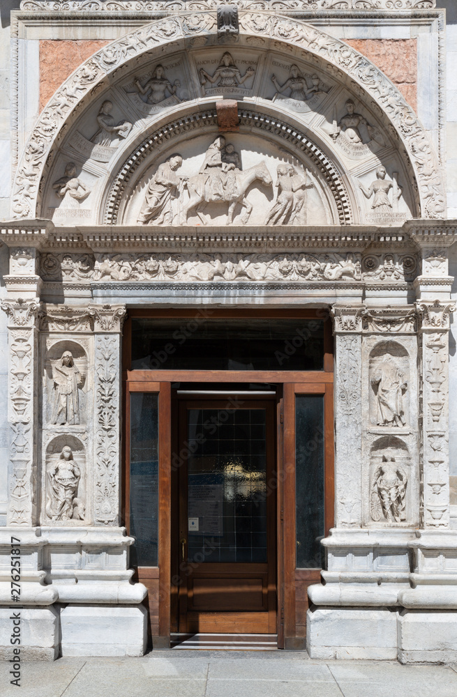 COMO, ITALY - MAY 9, 2015: The side portal of Duomo - cathedral with the relief of Flight to Egypt biblical scene.