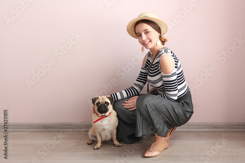 Teenage girl with cute pug ...