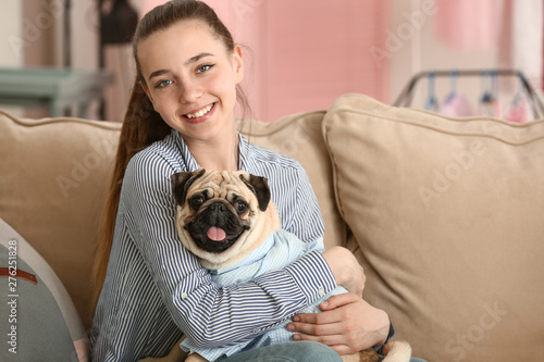 Teenage girl with cute pug ...