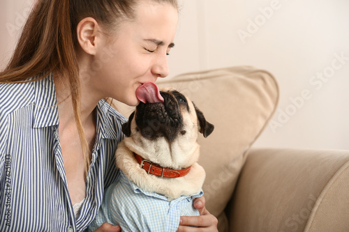 Teenage girl with cute pug ...