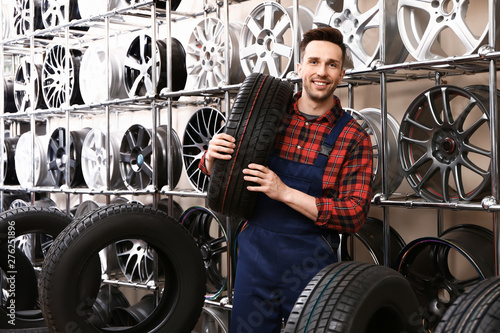 Male seller in car tire store