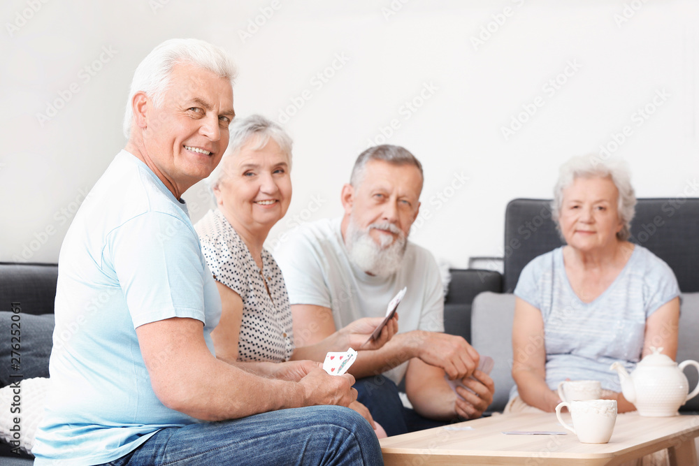 Portrait of elderly people playing cards in nursing home Portrait of elderly people playing cards in nursing home