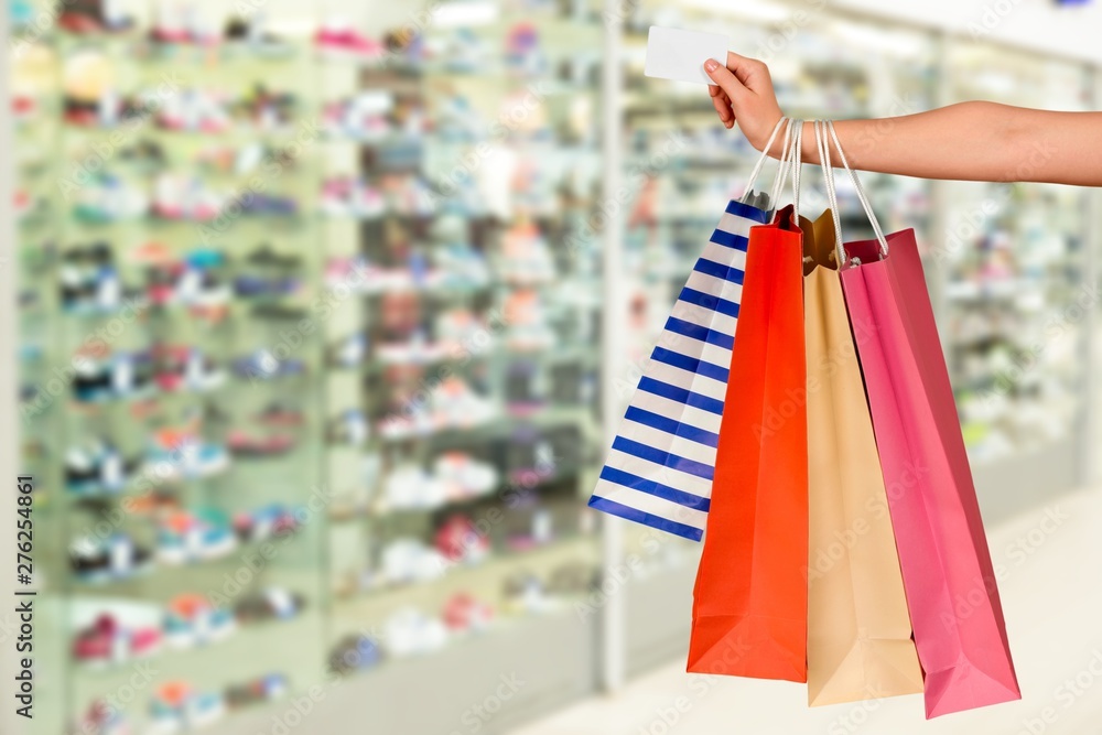Close up woman hand with many shopping bags and credit card Close up woman hand with many shopping bags and credit card