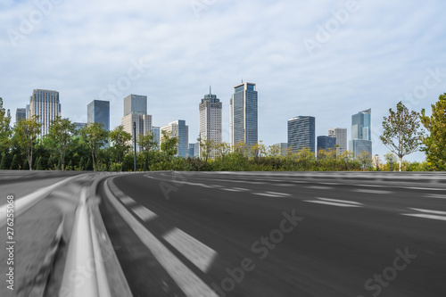 empty asphalt road on modern bridge with city skyline background. © hallojulie