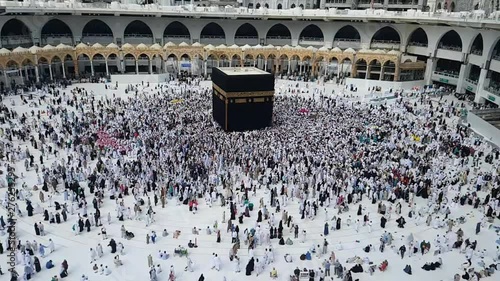 Muslim pilgrim umrah or hajj revolving circling tawaf around holy Kaaba inside masjidil haram mecca saudi arabia photo