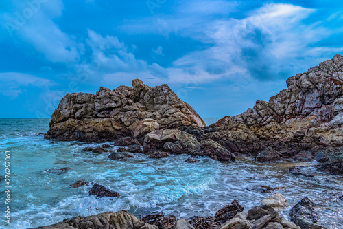Fresh air at the sea Beautiful stones being beaten by waves. © Narong Niemhom