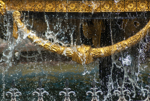 Close-up of the city fountain with gilded decor elements and dripping water  fountain in Tbilisi 