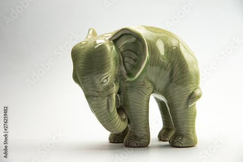 Charming green porcelain elephant isolated on white background.