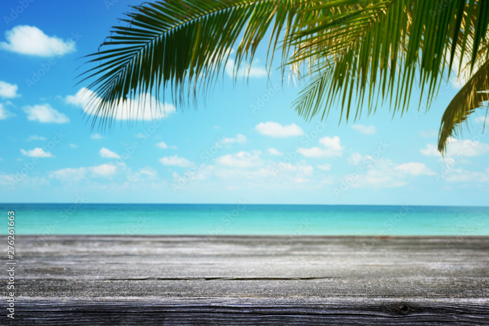 Wooden table and tropical beach background with palm tree, summer. Wooden table and tropical beach background with palm tree, summer.
