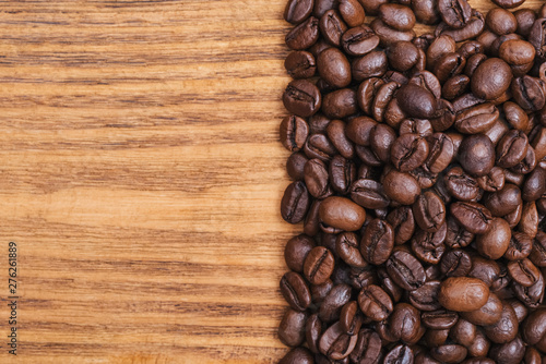Coffee bean. The background of roasted coffee beans is brown on wooden boards. layout. Flat lay. © andreyphoto63