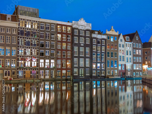 Historic houses reflecting off the water taken in Central, Amsterdam during the evening blue hour.