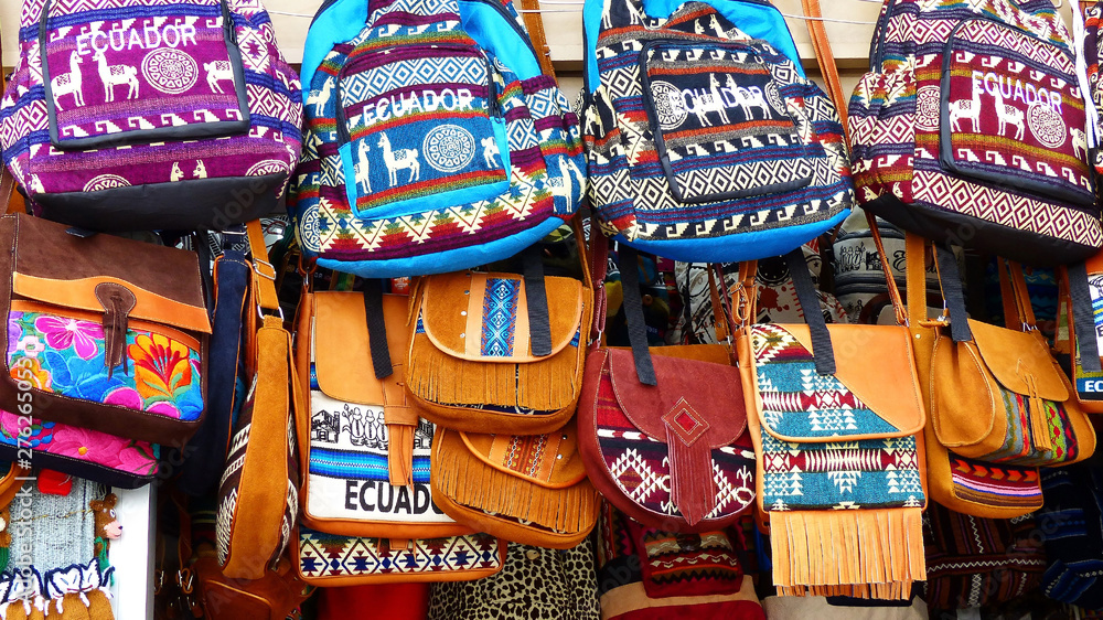 olorful bags and backpacks made from cloth and leather on the display at the artisan's market in Cuenca, Ecuador