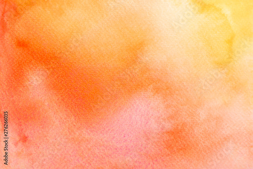 Abstract yellow and orange watercolor on paper. The color splashing in the paper. It is a hand drawn.