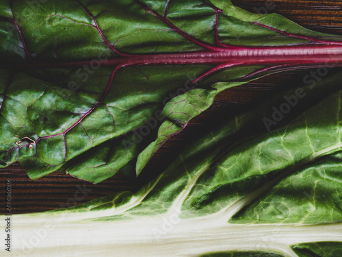 Raw mangold on wooden backgound, Fresh leaves of chard, close up