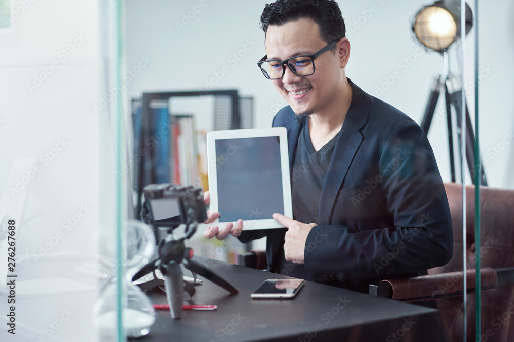 Asian young businessmen are recording video for social media , for commercial advertising.E-commerce concept . Asian young businessmen are recording video for social media , for commercial advertising.E-commerce concept .