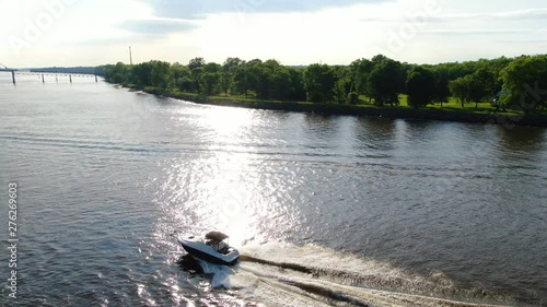 180 flight over a speed boat revealing an old truss bridge photo