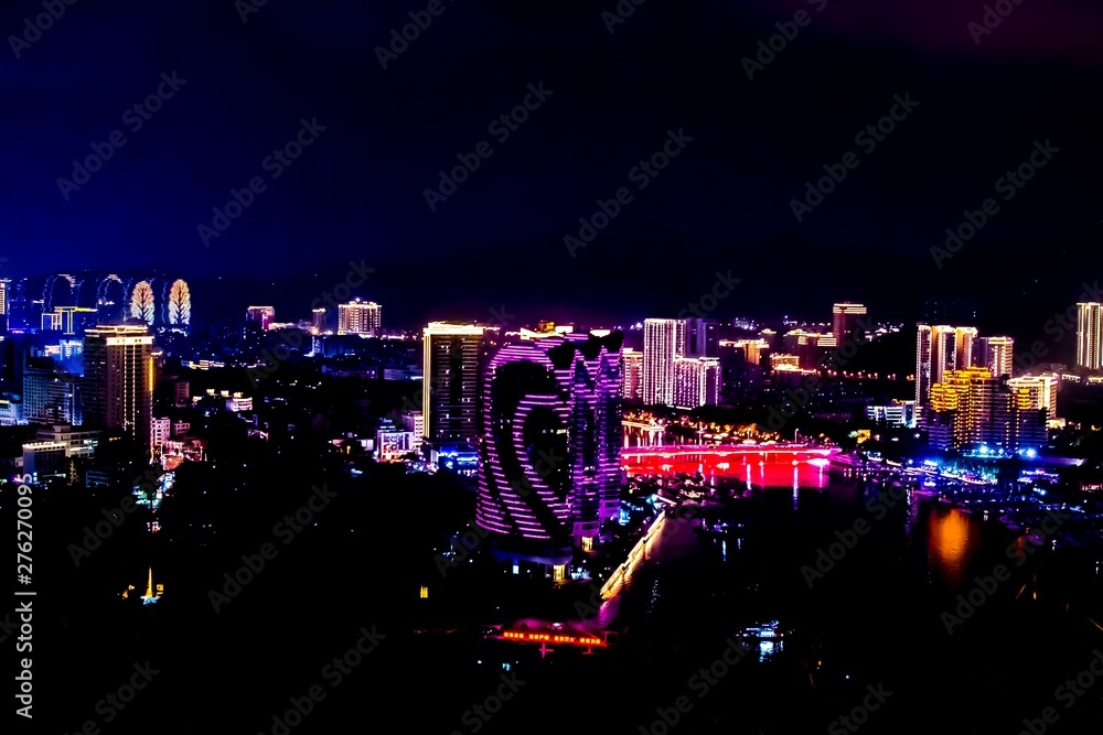 View of the night city of Sanya. Hainan Island, China. Neon lights of the night metropolis. Blur.