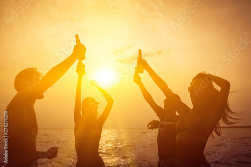 Group of friends having party at the beach photo