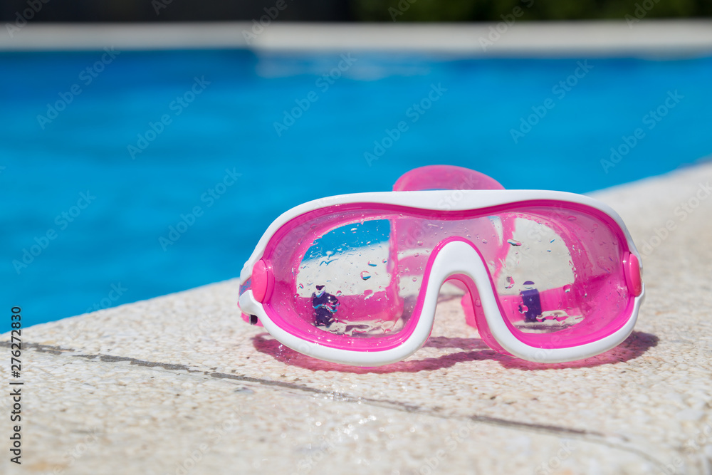 Image of swimming pool, goggles and swimming hat. Nobody