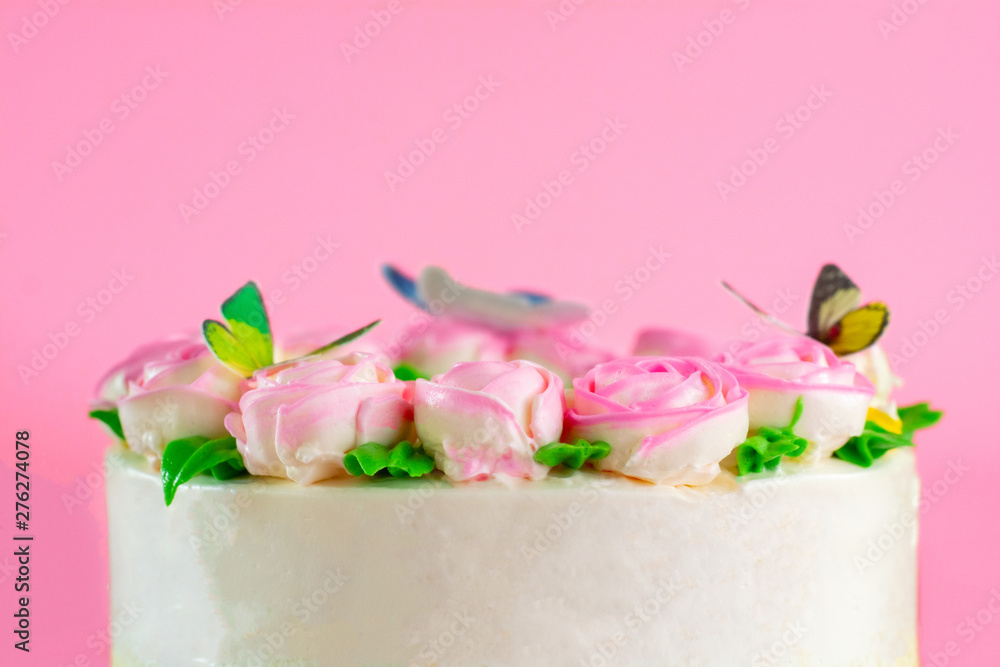 Buttercream frosting of Pink Roses decorated on vanilla pond cake on pink background with copy space served in Birthday Party and wedding. Delicious sweet bakery for someone you love.