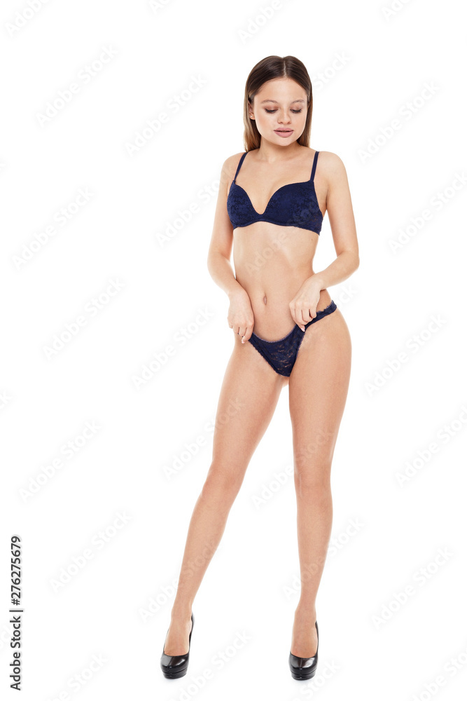 Girl in lingerie straightens her pants with her hands. Girl in lingerie straightens her pants with her hands.
