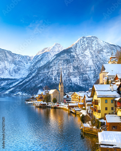 Obraz na płótnie Classic postcard view of famous Hallstatt lakeside town in the Alps with traditional passenger ship on a beautiful cold sunny day with blue sky and clouds in winter, Austria w salonie