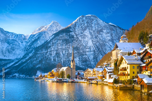 Obraz na płótnie Classic postcard view of famous Hallstatt lakeside town in the Alps with traditional passenger ship on a beautiful cold sunny day with blue sky and clouds in winter, Austria w salonie