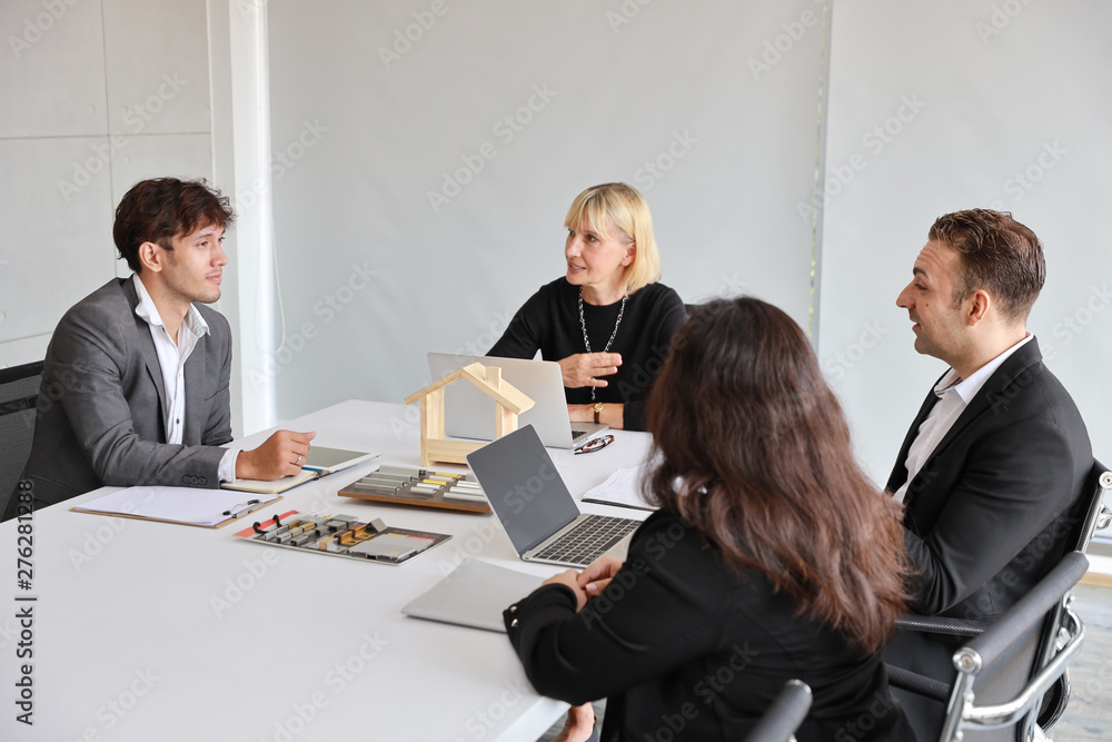 Multiethnic business people discussing company about new house project in meeting room with smiling and happy faces Multiethnic business people discussing company about new house project in meeting room with smiling and happy faces