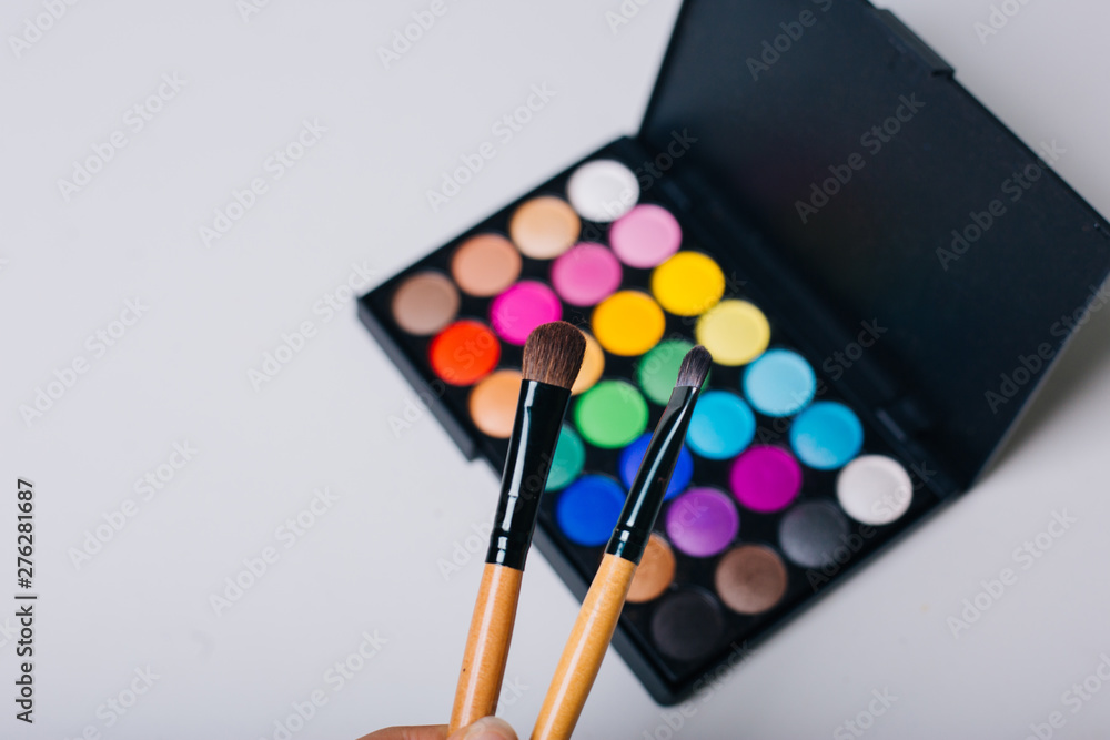 Naklejka premium Bright shadows and make-up brushes. Beauty and Fashion