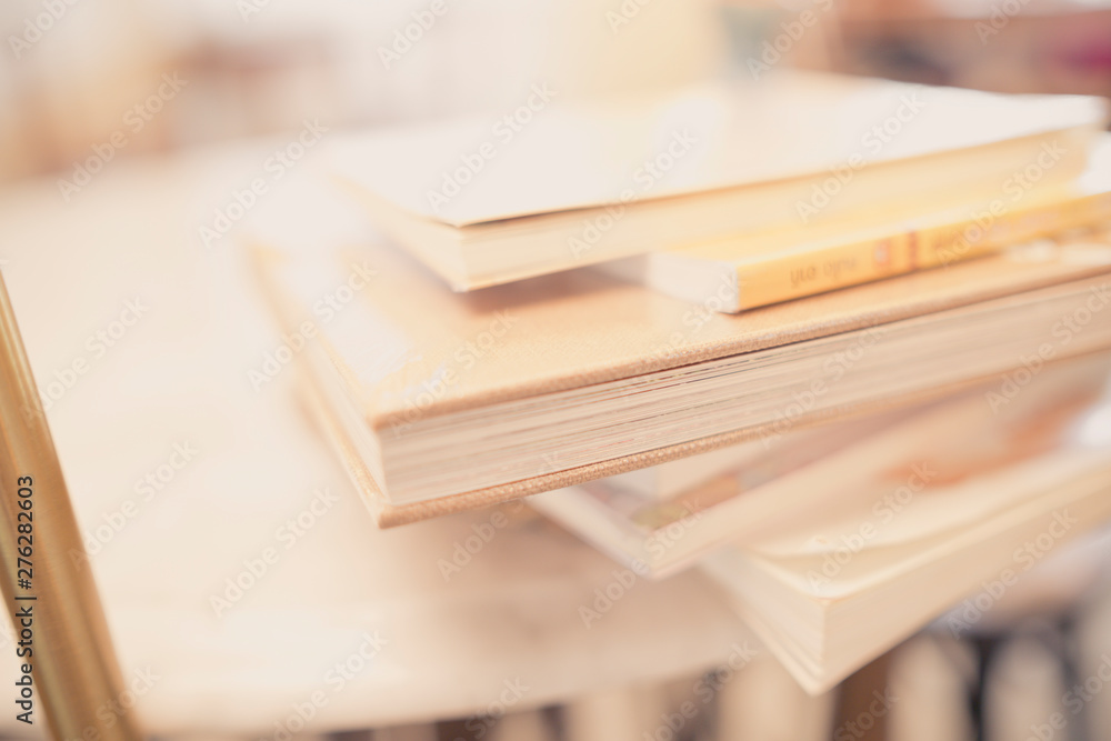 close up books stacking on table in room and warm light close up books stacking on table in room and warm light