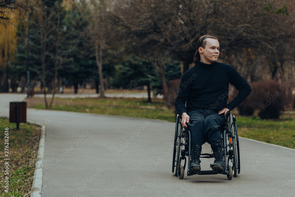 Portrait of a happy man on a wheelchair in a park Portrait of a happy man on a wheelchair in a park