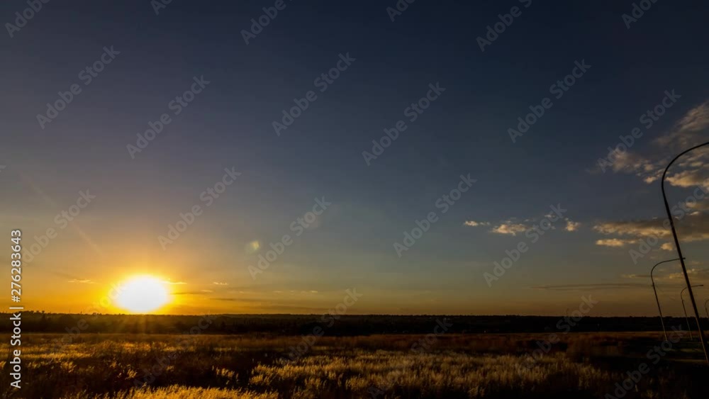 Sunset time lapse with sun setting and clouds floating past. Sunset time lapse with sun setting and clouds floating past.