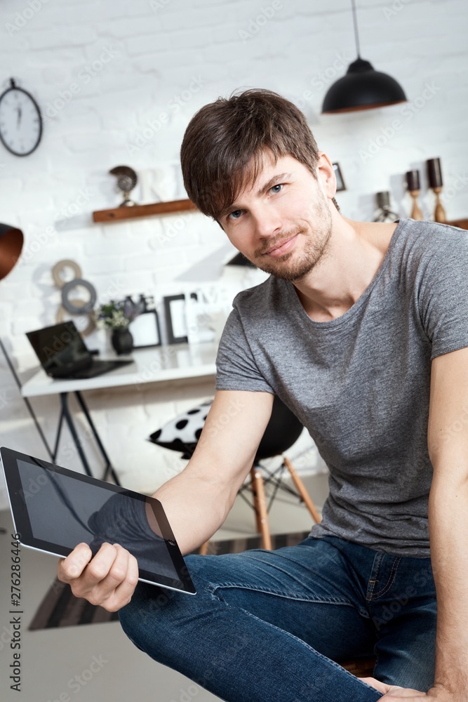 Young man holding tablet Young man holding tablet