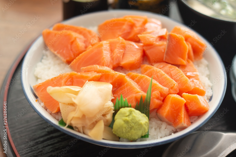 Salmon Donburi or Salmon sushi don, Japanese food on wooden desk background Salmon Donburi or Salmon sushi don, Japanese food on wooden desk background