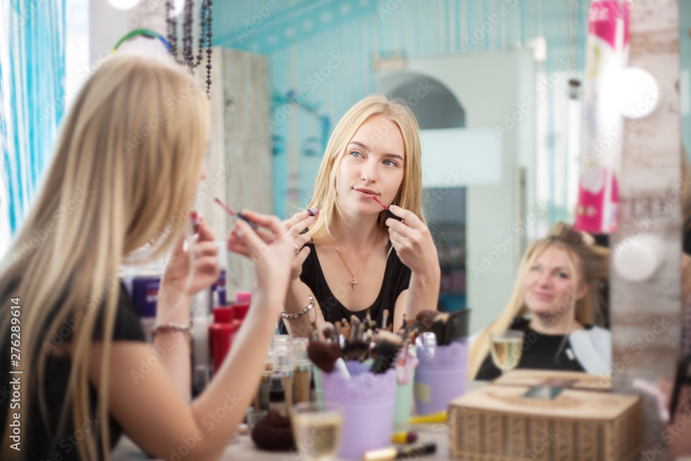 Pretty woman. Selective focus of a beautiful young woman looking at her reflection in the mirror.