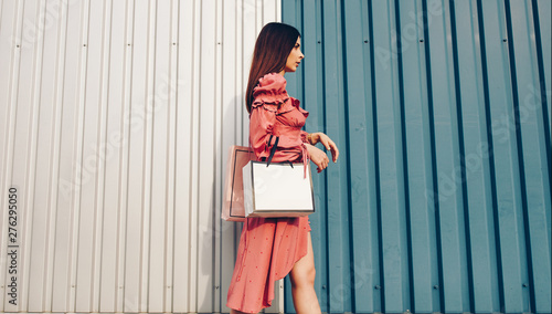 sale, shopping, tourism and happy people concept - beautiful woman with shopping bags in the ctiy photo