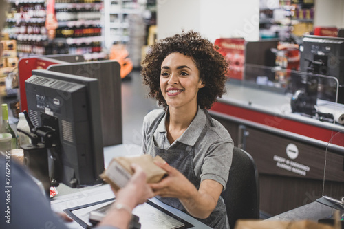 Sales clerk working at grocery store photo