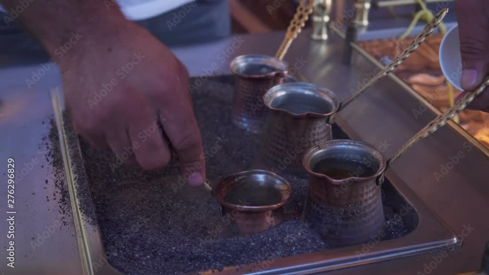 Hands brewed traditional coffee in sand on the turkish street. Hands brewed traditional coffee in sand on the turkish street.